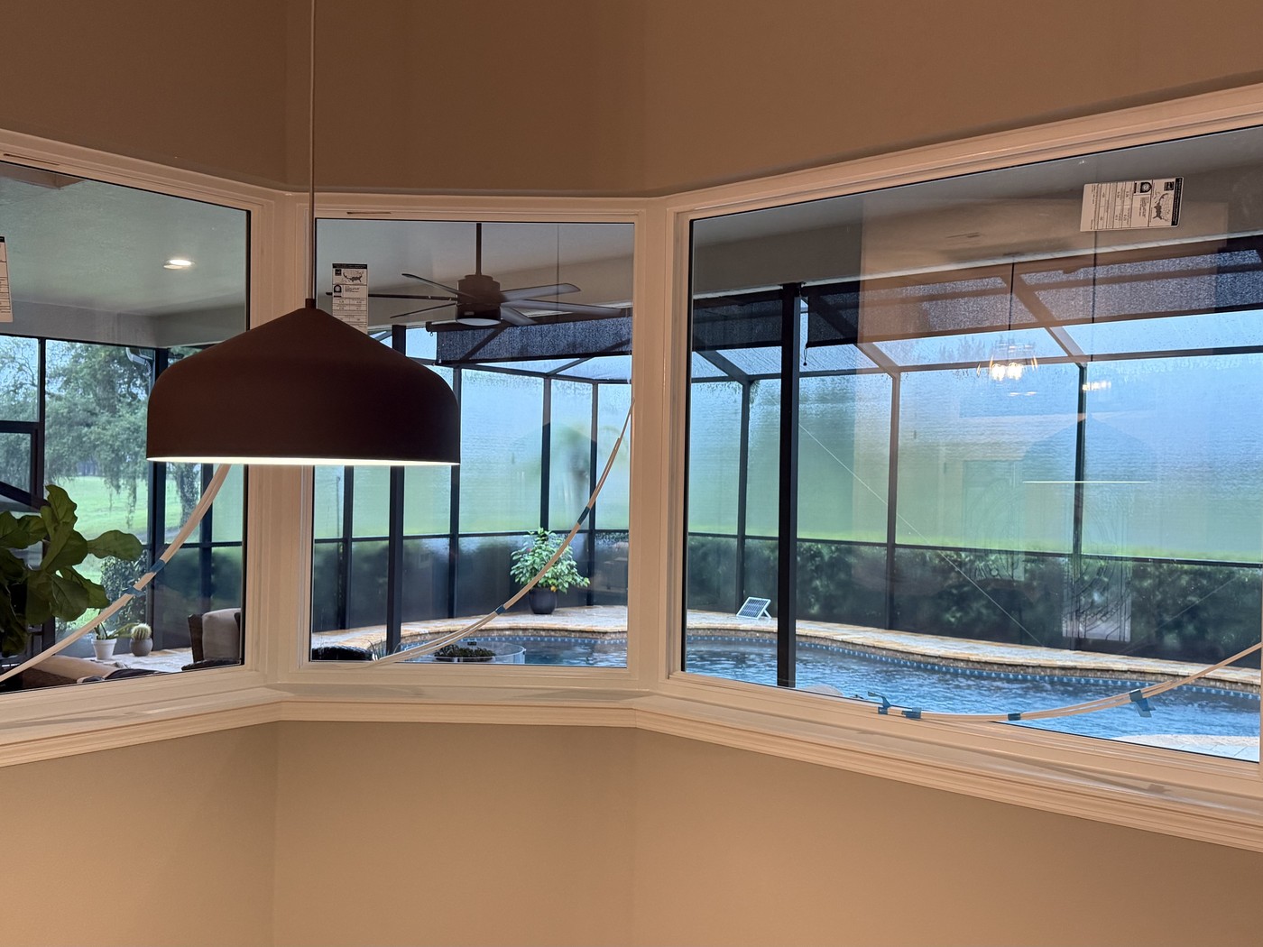 Finished bay window nook with pendant lighting and a wide marina view.
