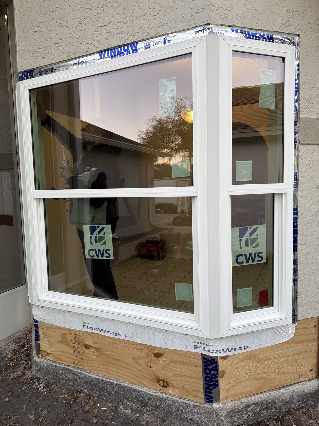 Finished impact-rated bay window installed and sealed over the repaired framing.